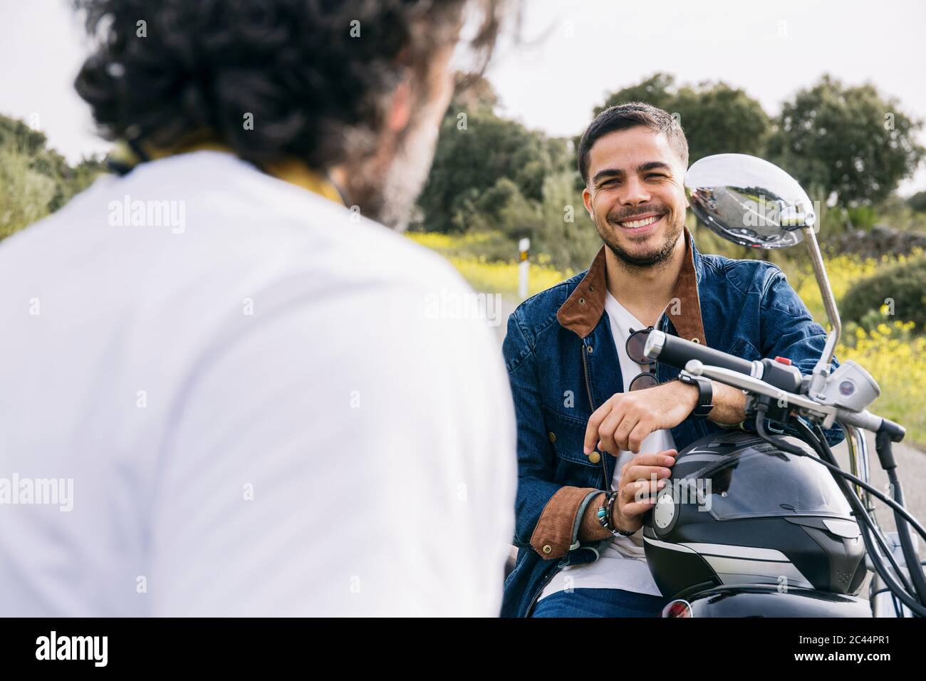 Happy smiling and screaming male tourist in helmet and sunglasses riding motorbike  scooter during his tropical vacation under palm trees Stock Photo - Alamy