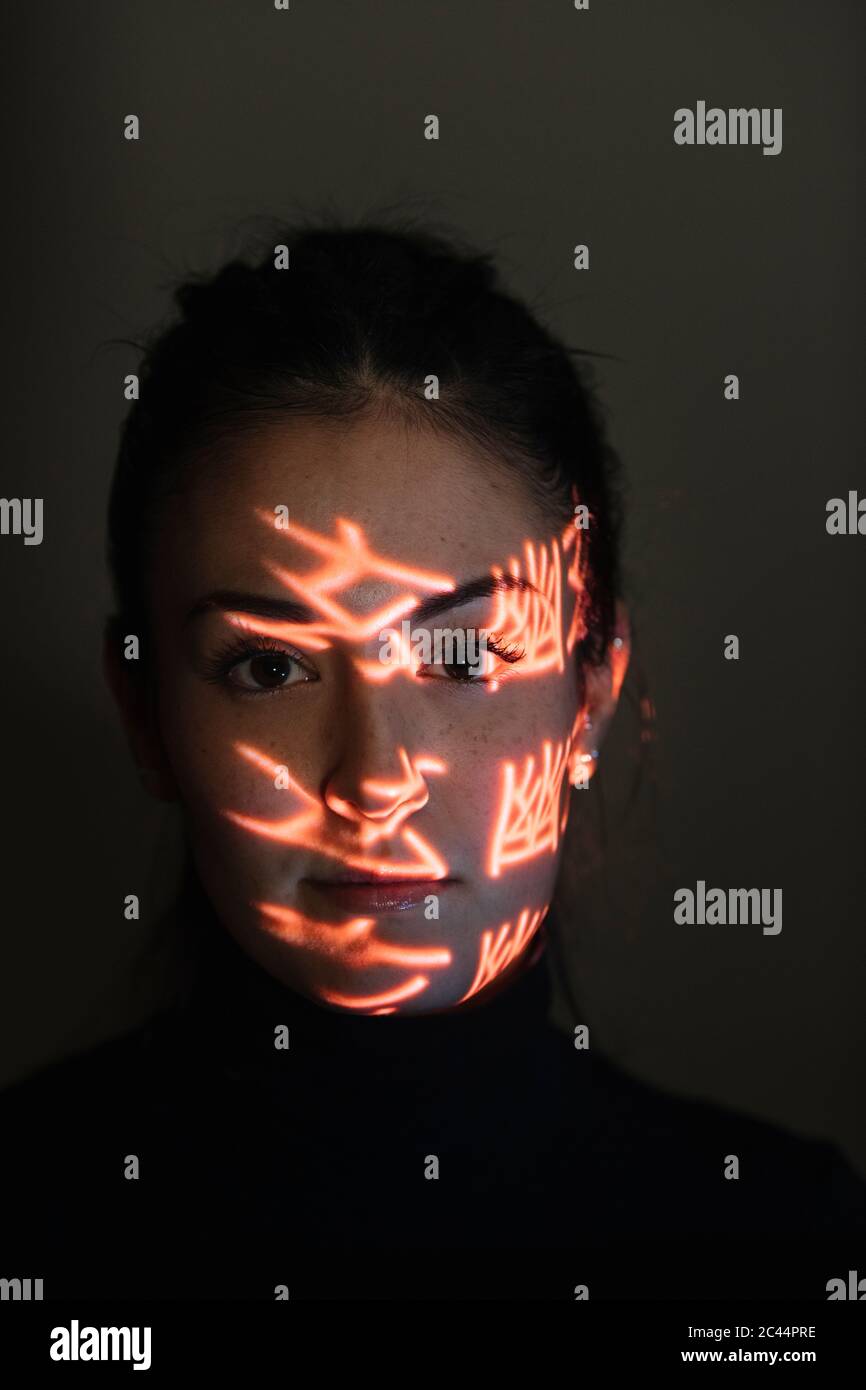Face of beautiful woman covered in light patterns Stock Photo - Alamy