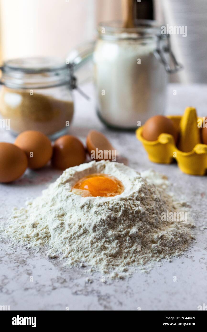 Close-up of egg yolk in flour Stock Photo