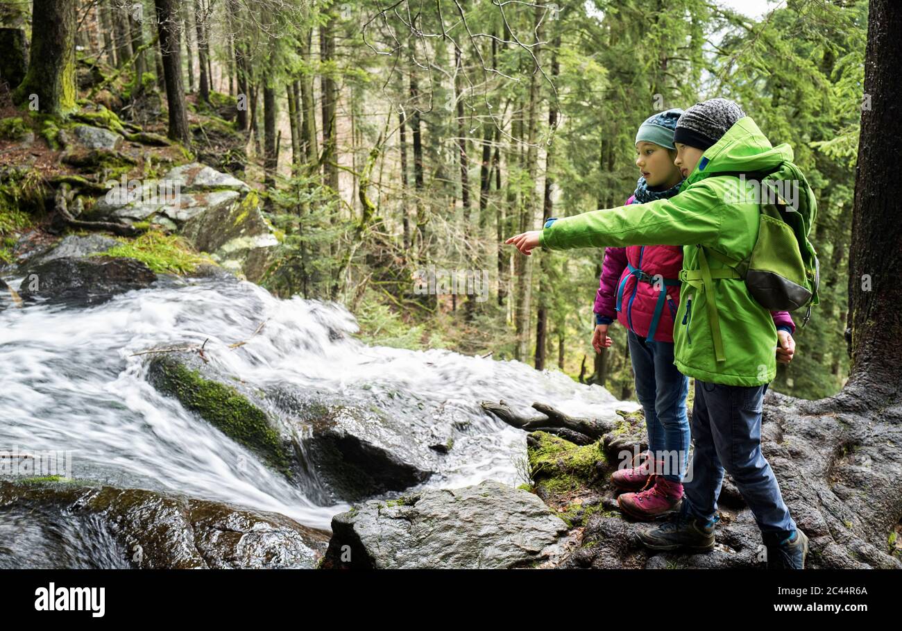Boy and girl looking at waterfall in Northern Black Forest Stock Photo