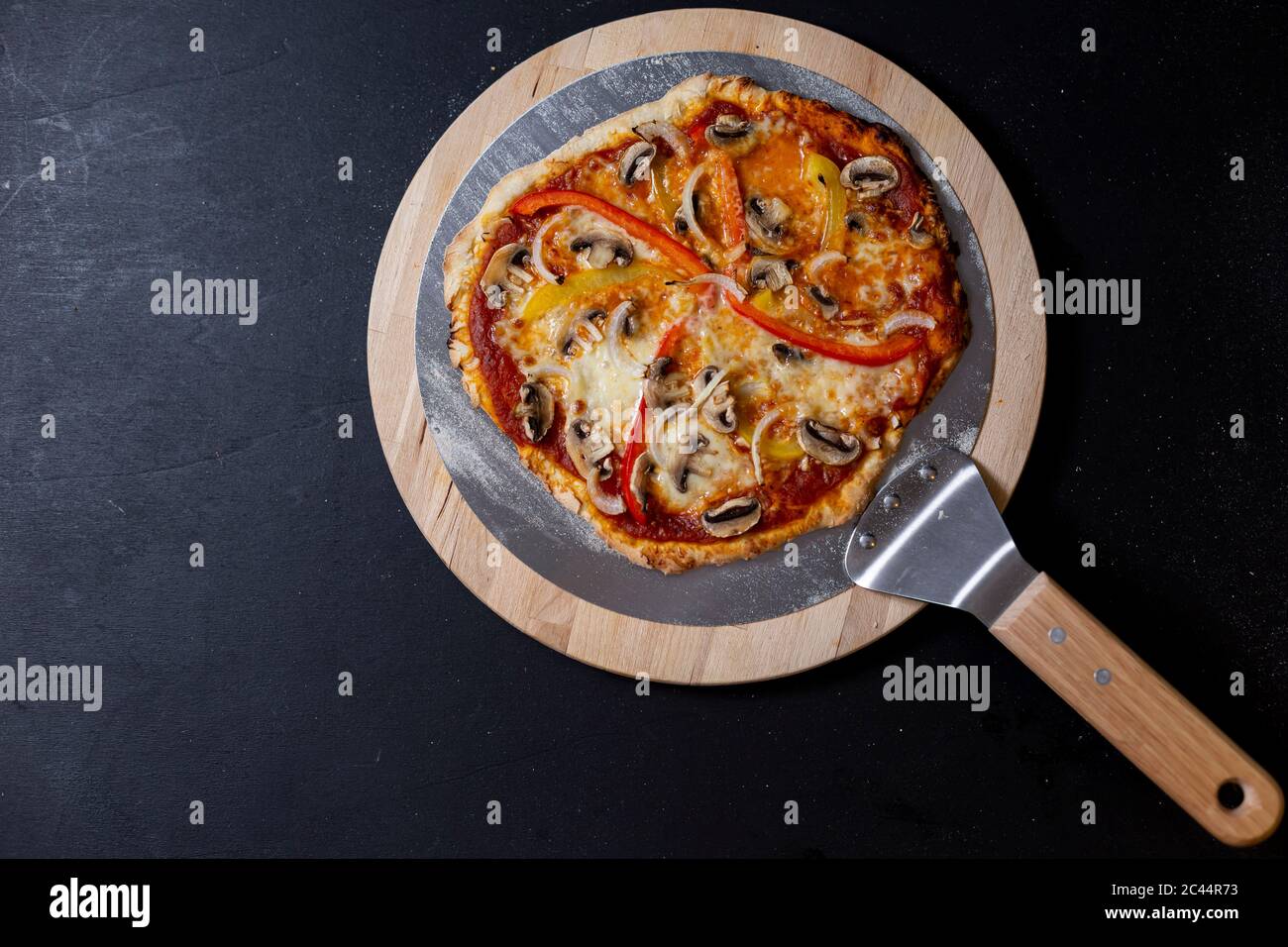 Studio shot of homemade vegetarian pizza with Mozzarella, mushrooms, paprika and onions Stock Photo