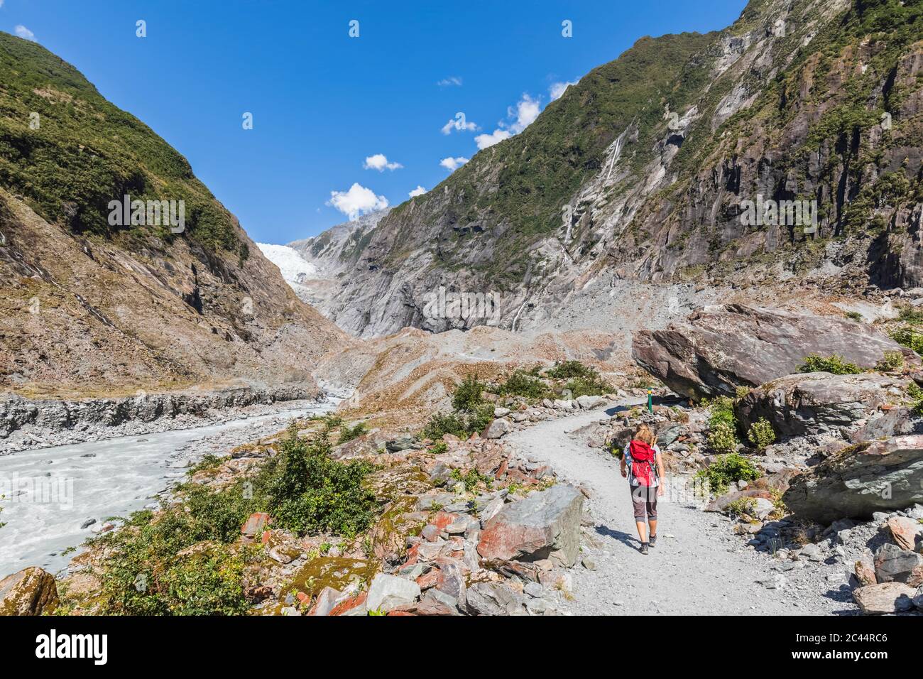 New Zealand, Westland District, Franz Josef, Female backpacker hiking in Franz Josef Glacier Stock Photo