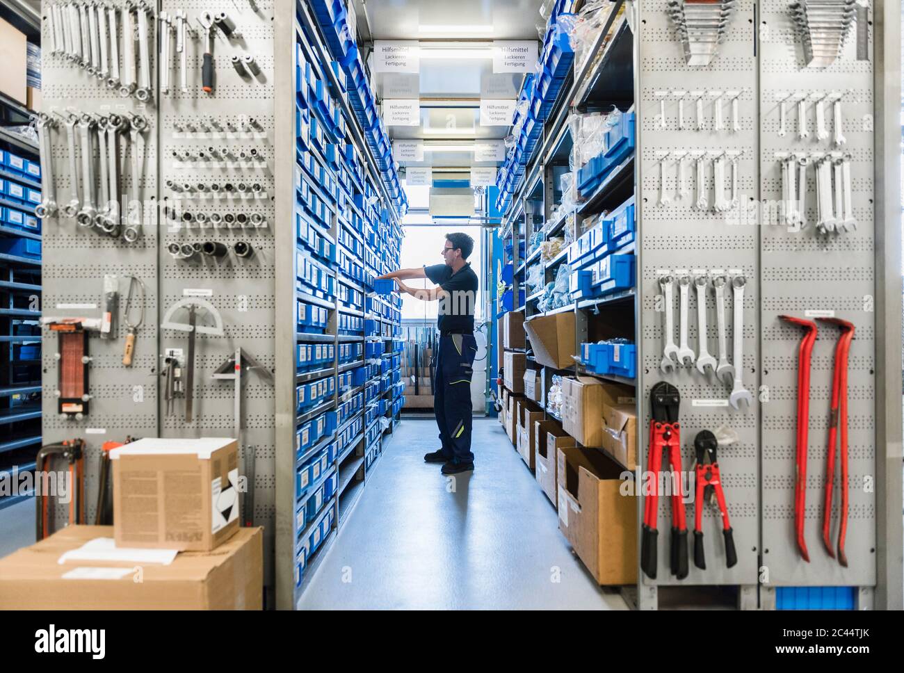 Man in storage room of a factory Stock Photo