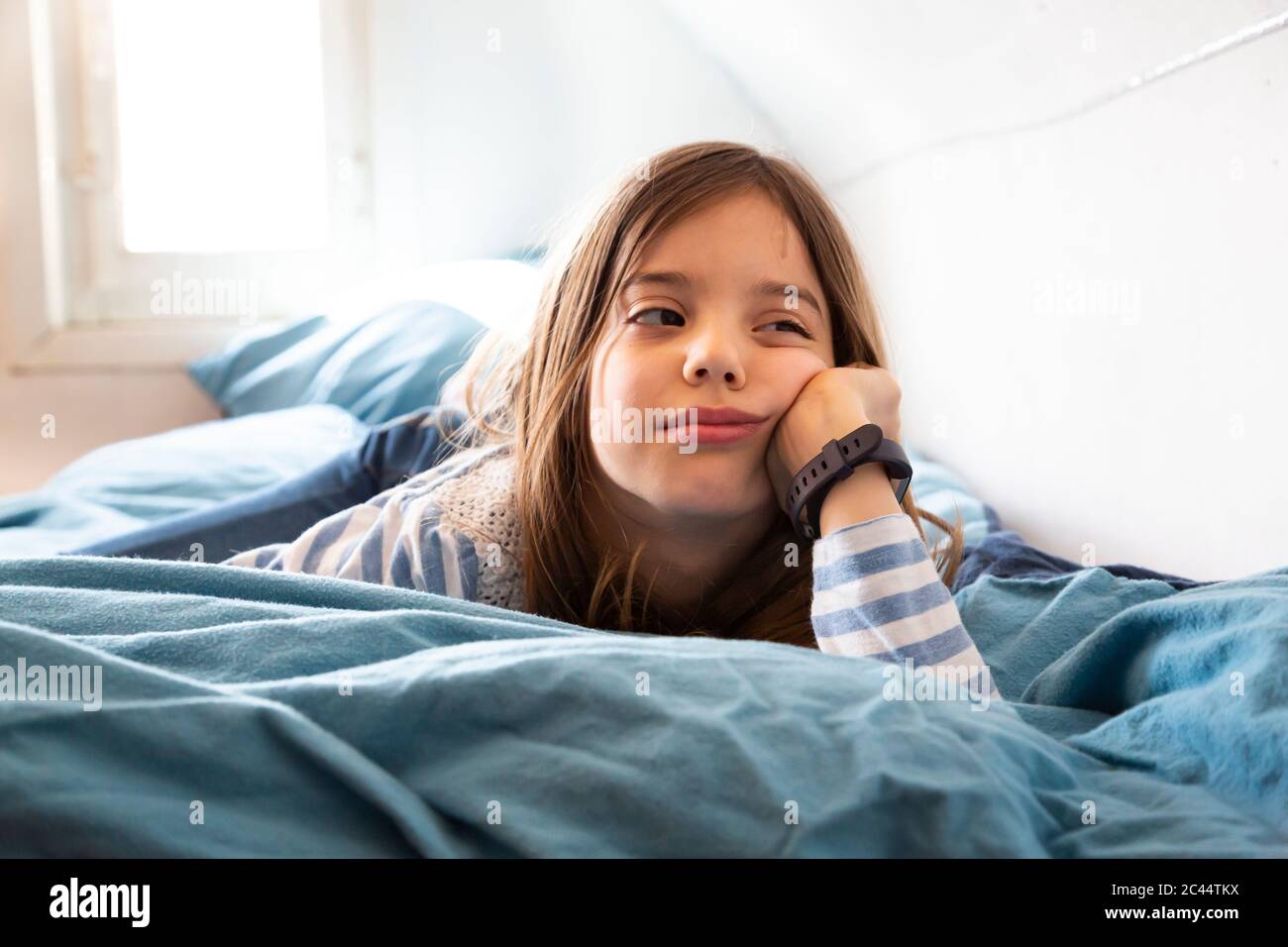 Portrait Of Bored Little Girl Lying On Bed Stock Photo Alamy