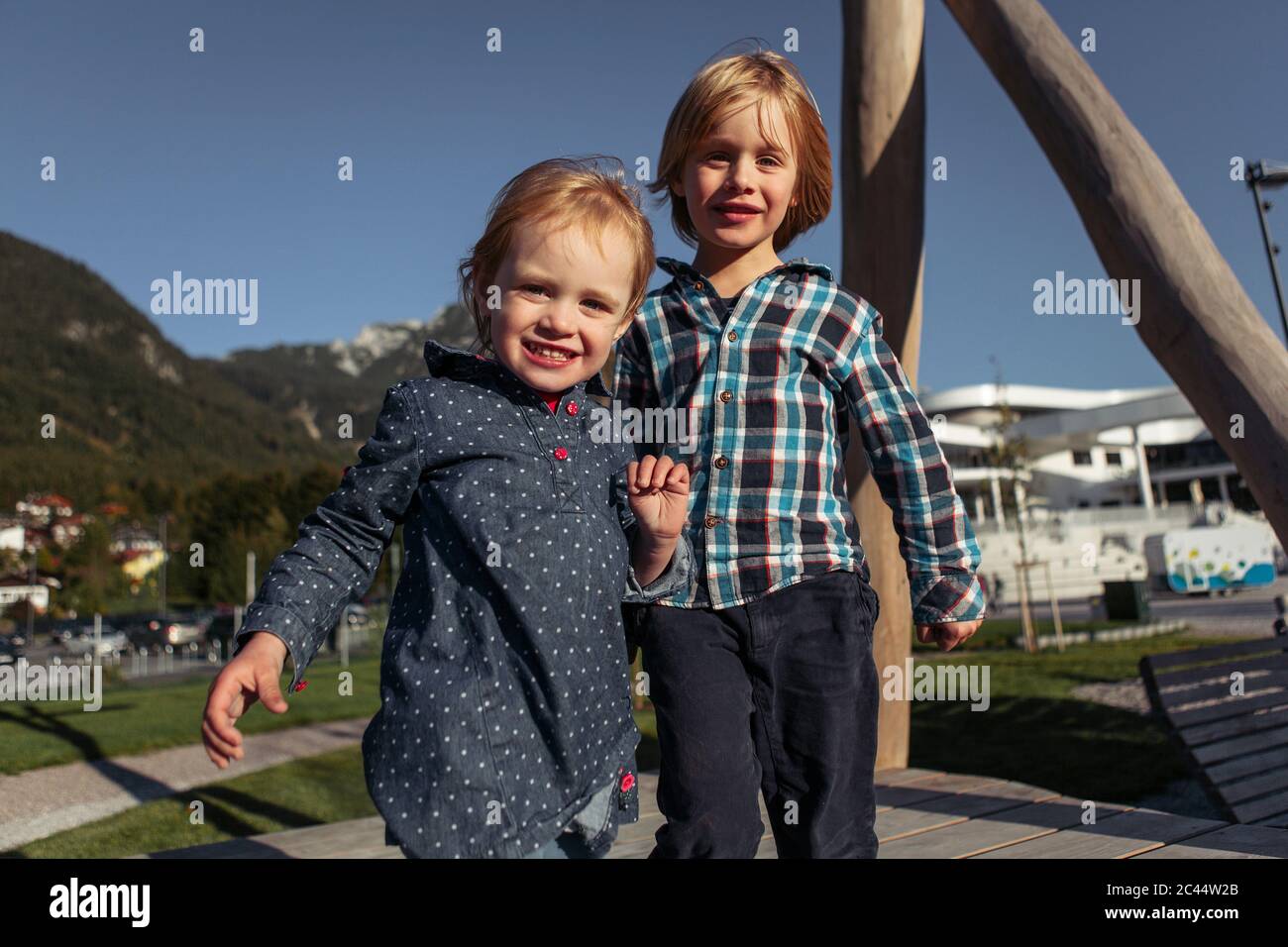 Siblings standing on boardwalk at Achensee, Tyrol State, Austria Stock Photo