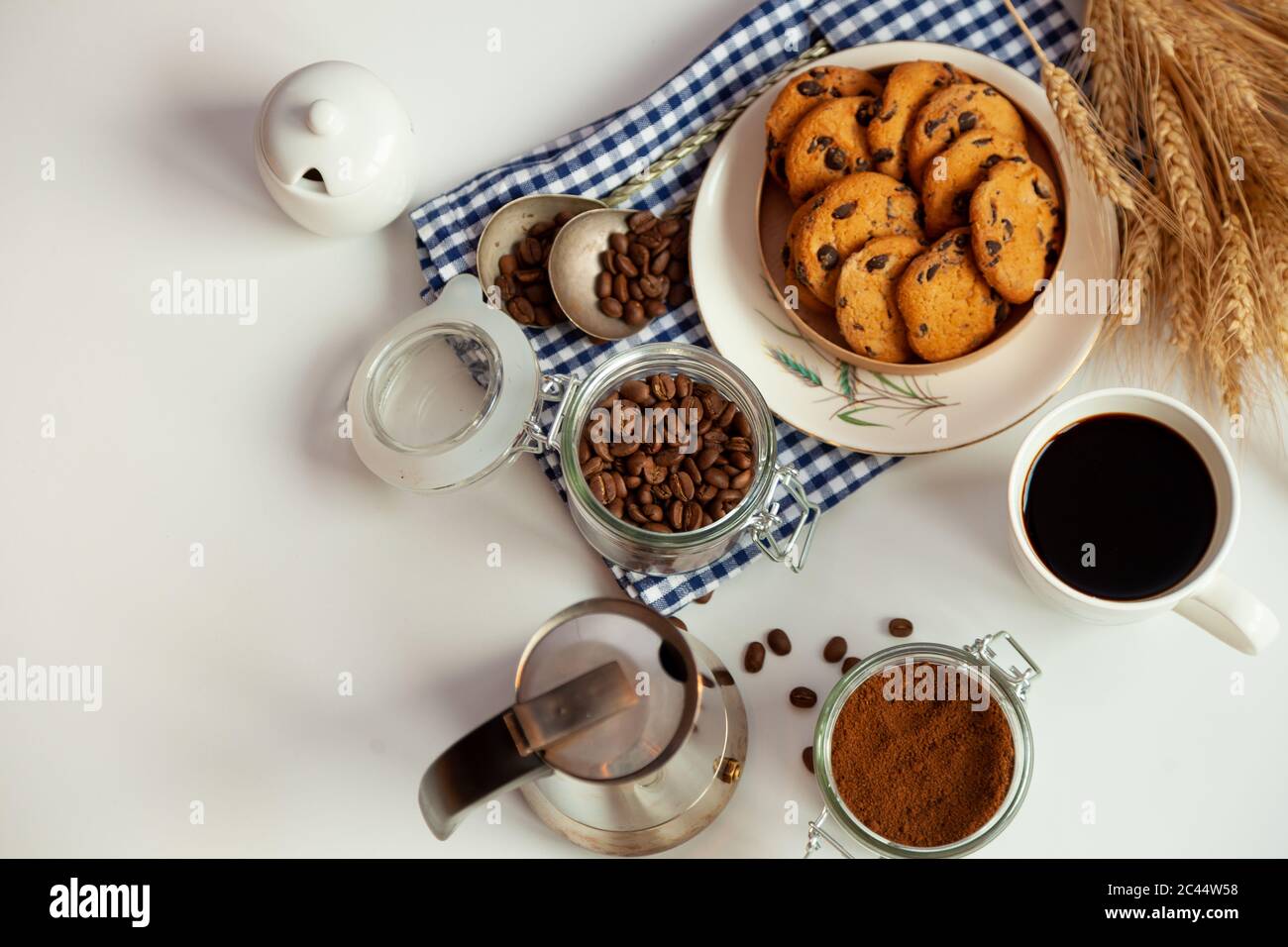 Breakfast top view. Coffee grains poured from a can on kitchen table ...