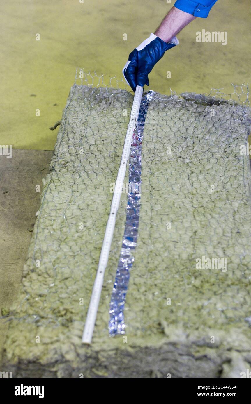Man uses a folding rule in a factory Stock Photo Alamy