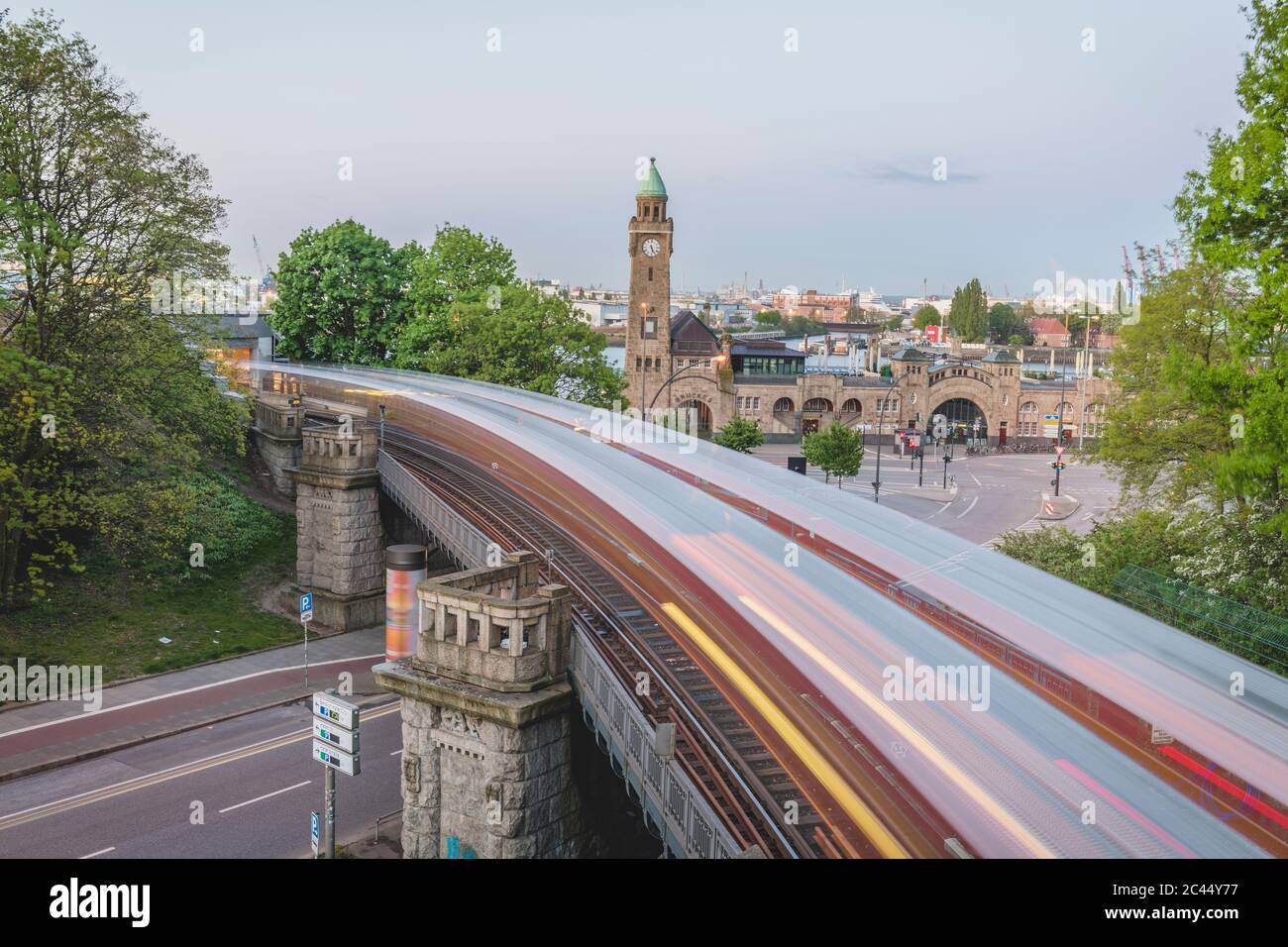 Germany, Hamburg, Blurred motion of elevated train passing Saint Pauli Piers Stock Photo