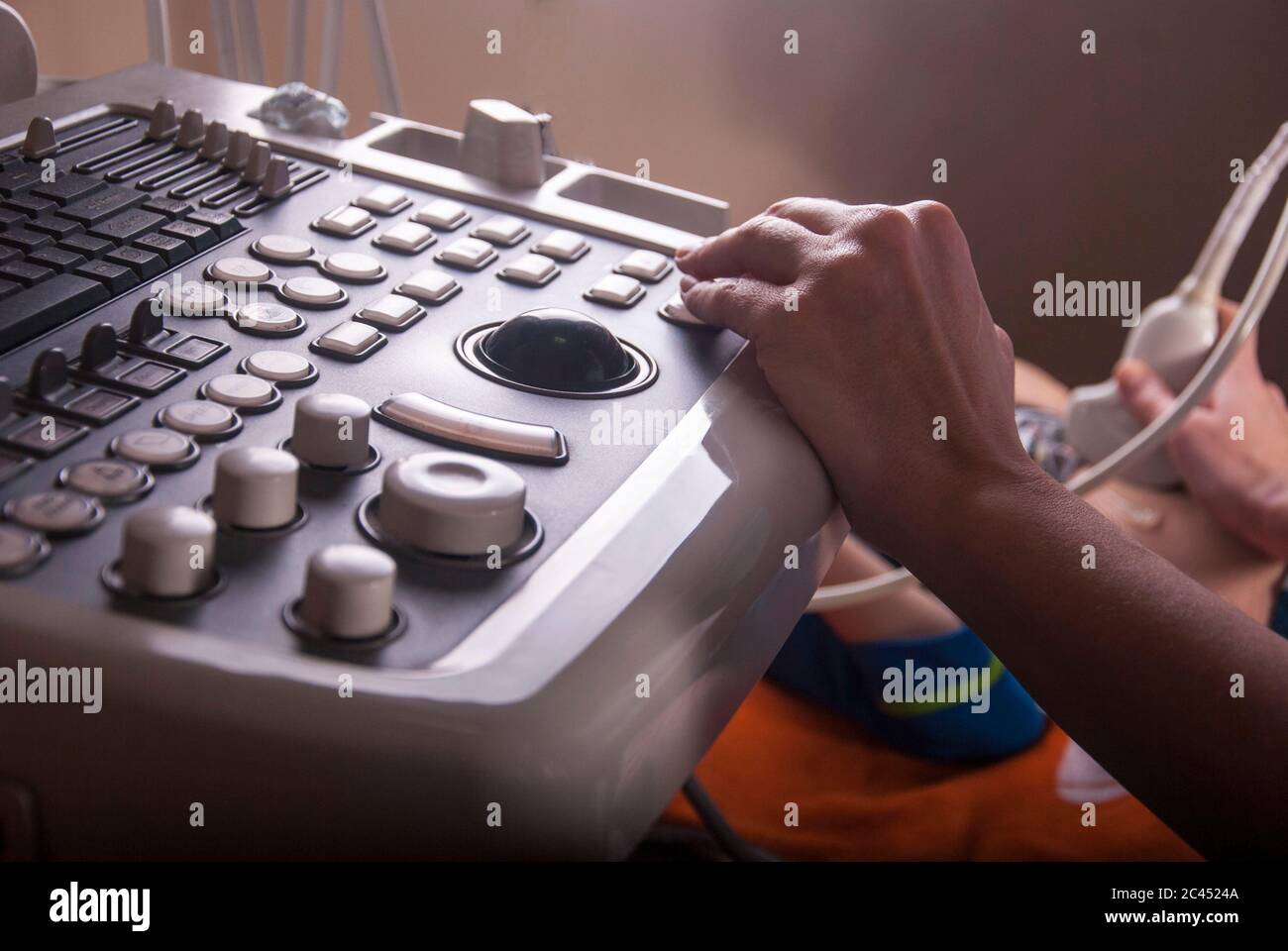 An ultrasound doctor examines the neck and abdomen in a child using an