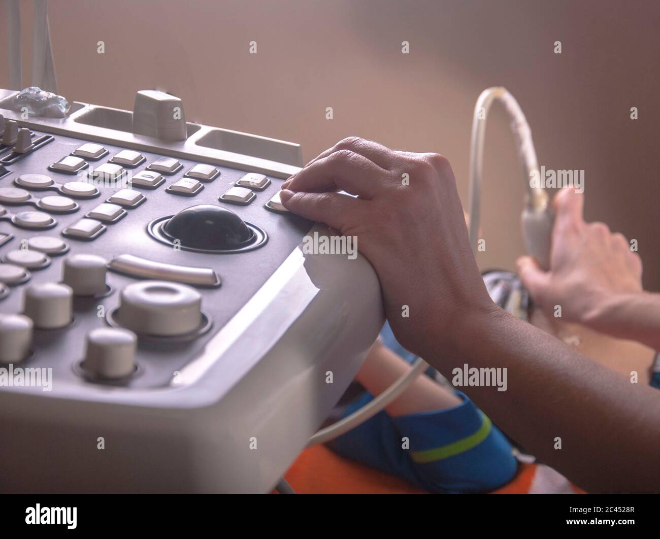 An ultrasound doctor examines the neck and abdomen in a child using an