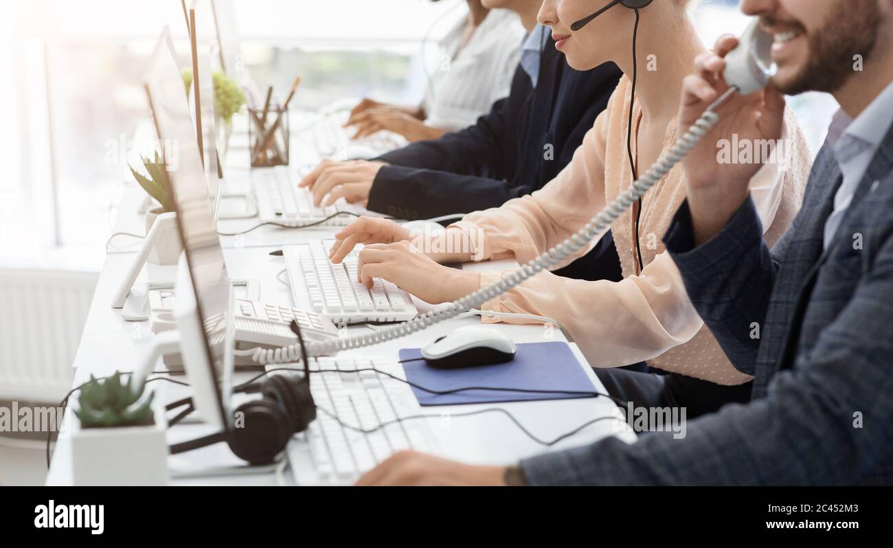 Closeup view of customer support operators working at call centre, copy space Stock Photo