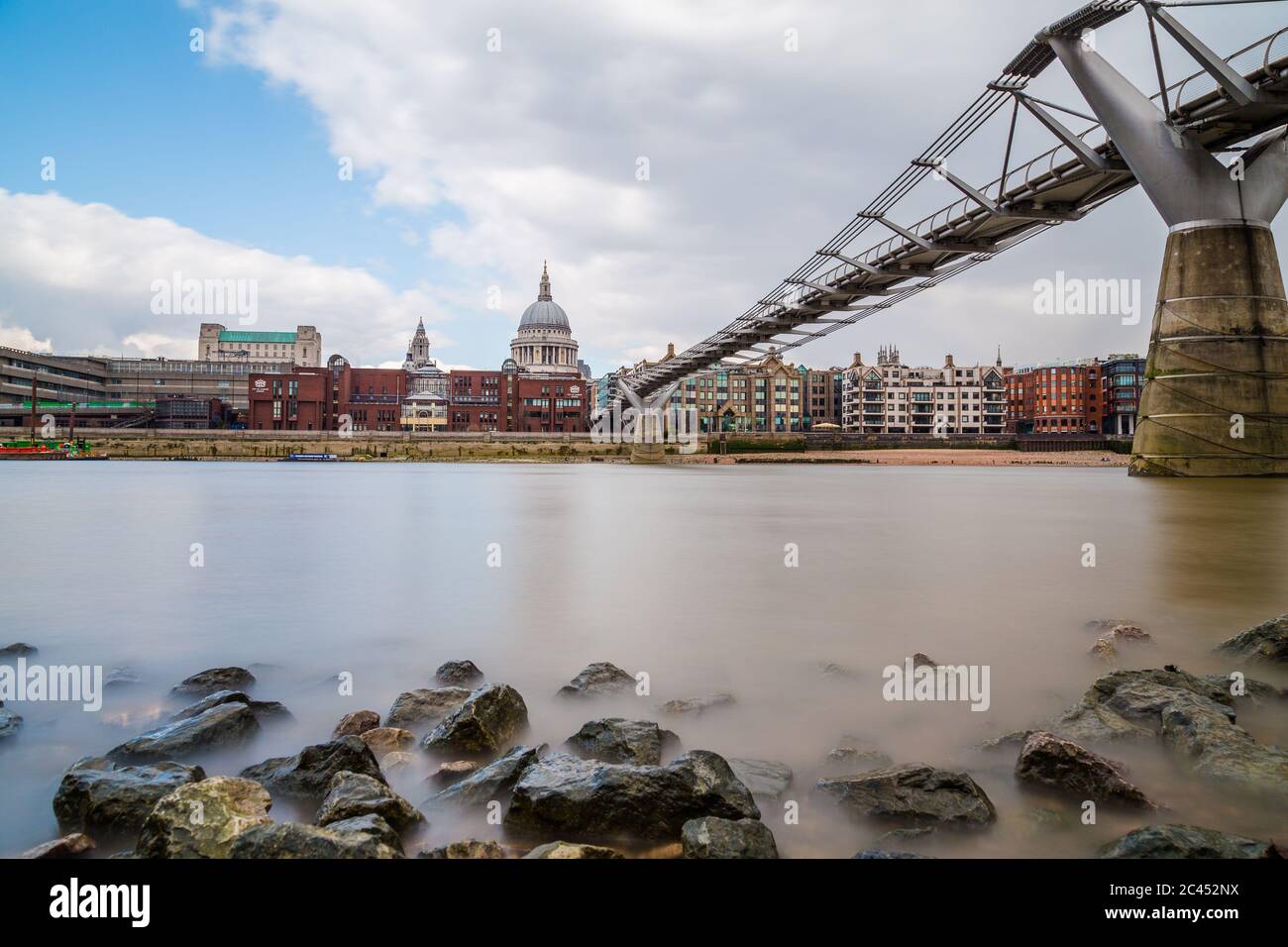 LONDON, UK - 24TH MARCH 2015: St Paul's Cathedral and Millenium Bridge in London during the day. Taken with a long exposure Stock Photo