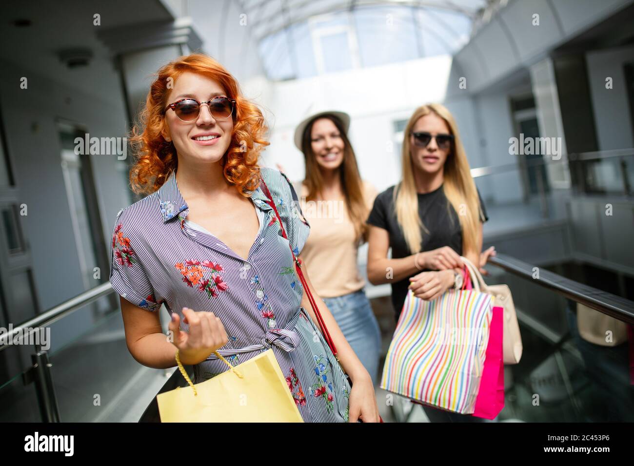 Beautiful women with shopping bags walking at the mall Stock Photo - Alamy