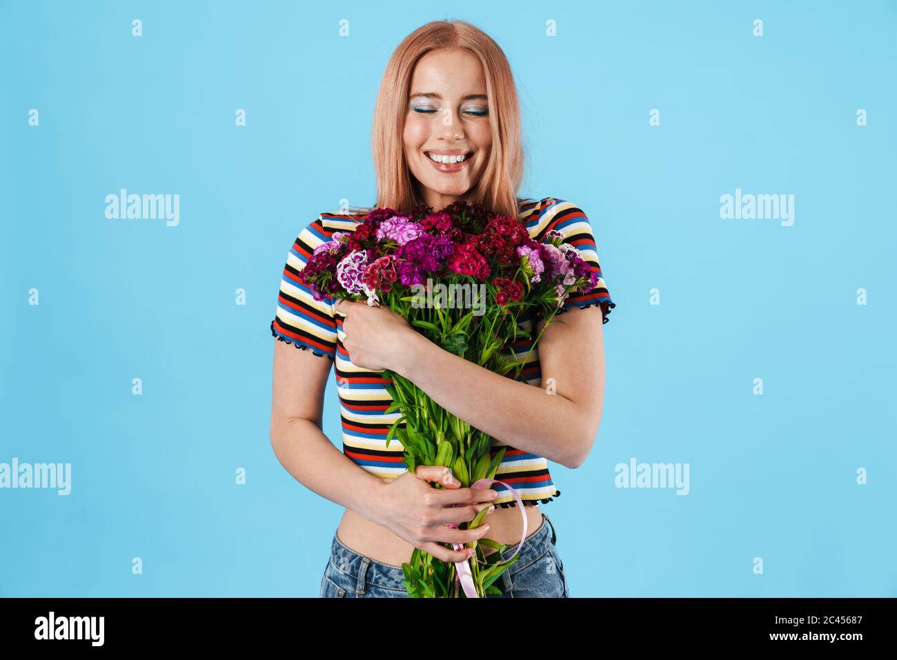 Image of cheerful beautiful pretty girl posing with flowers and smiling ...