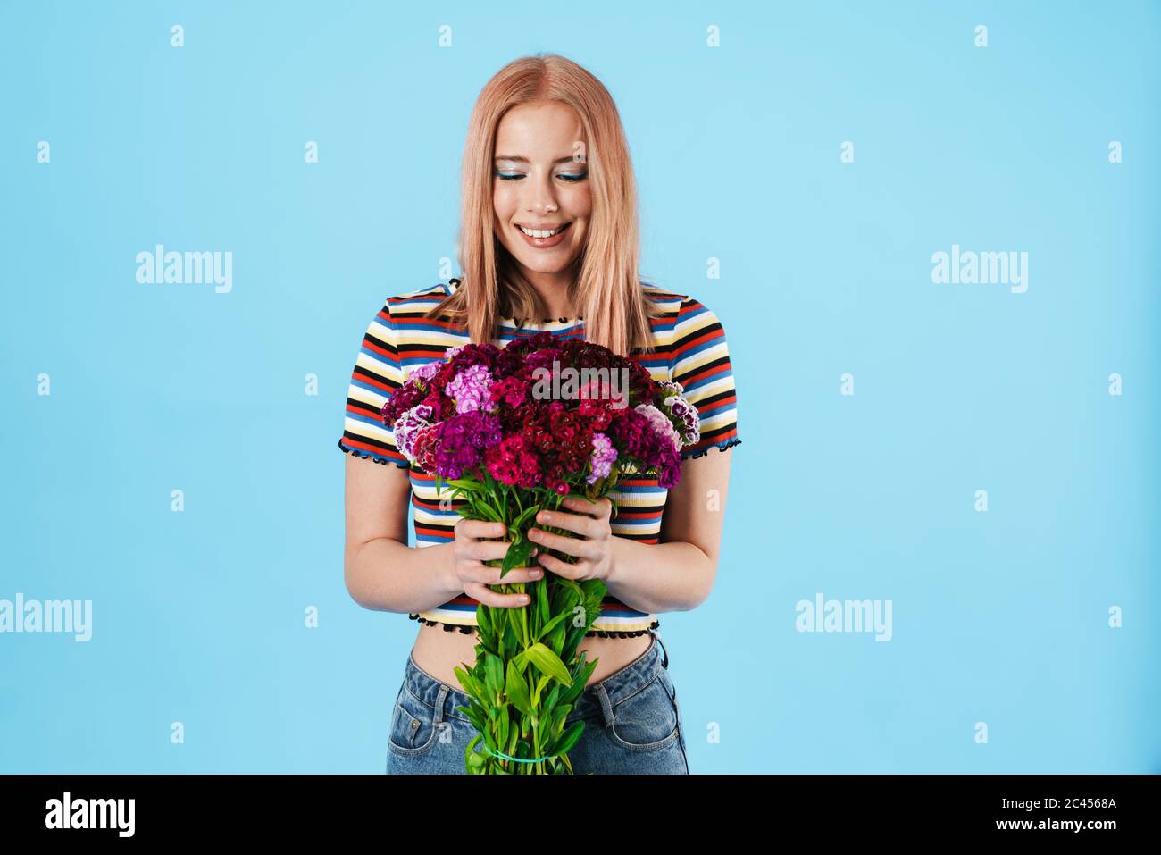 Image of cheerful beautiful pretty girl posing with flowers and smiling ...