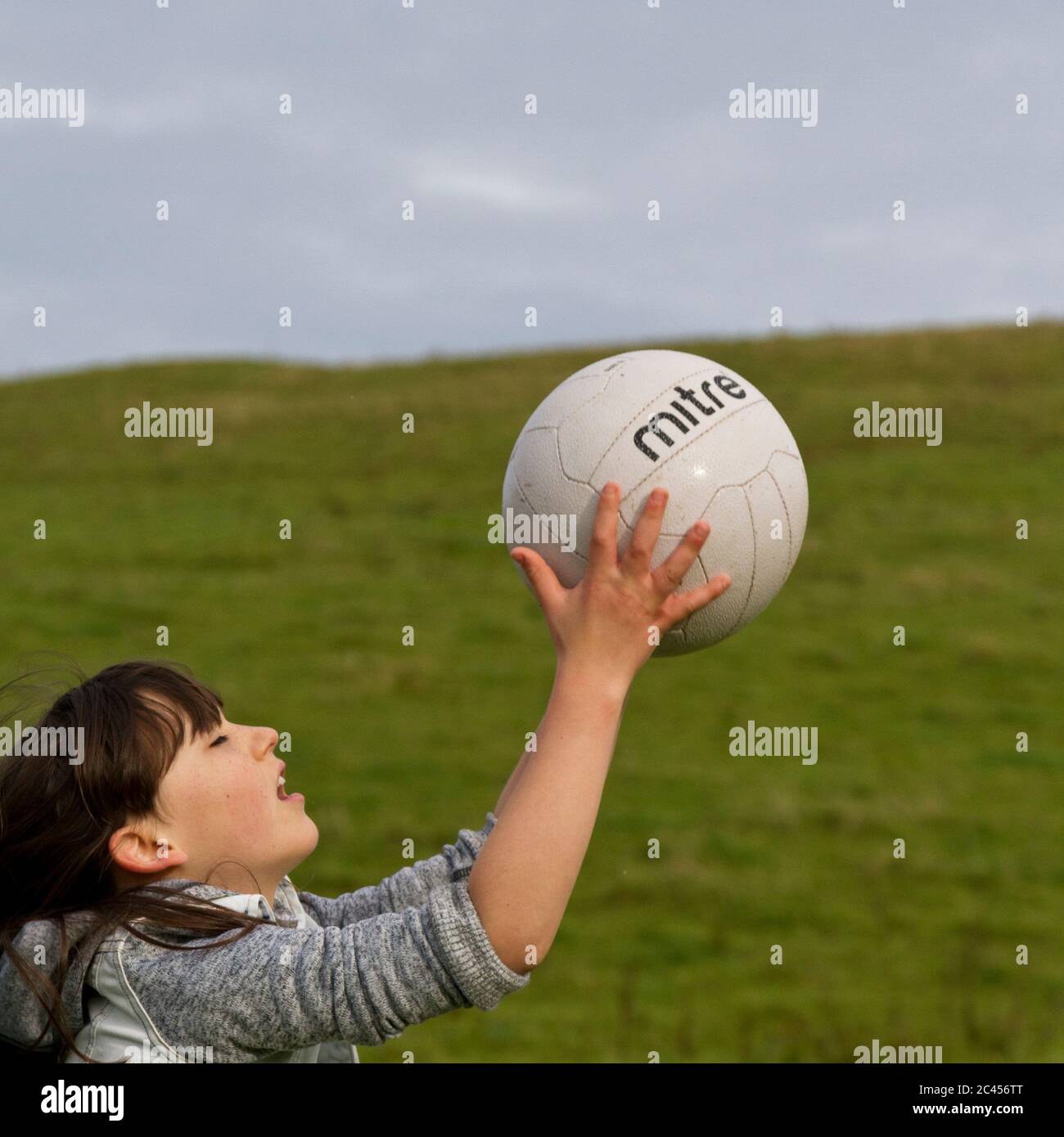 Young girl catching a ball Stock Photo