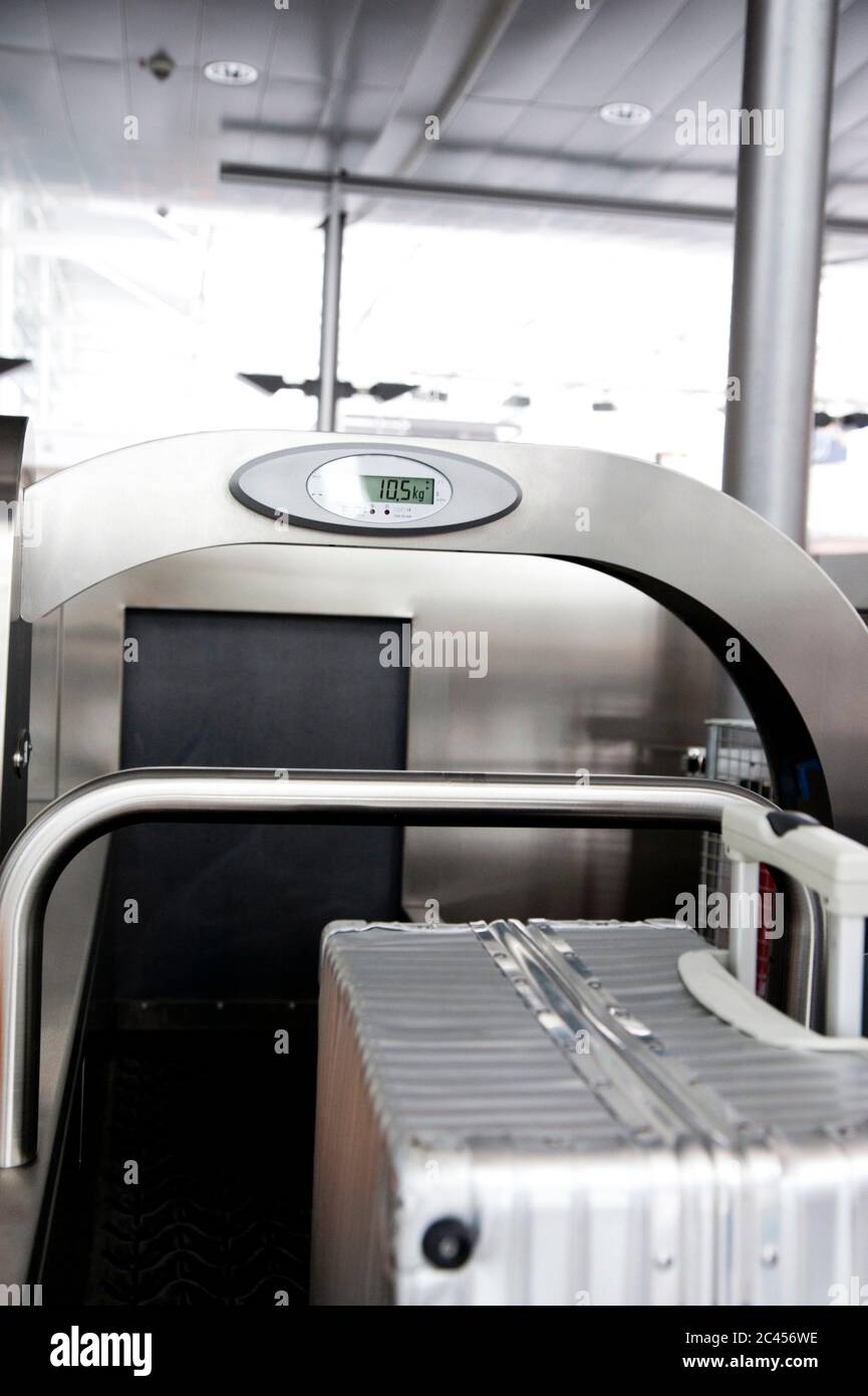 Weighing scales at an airport checkin Stock Photo Alamy