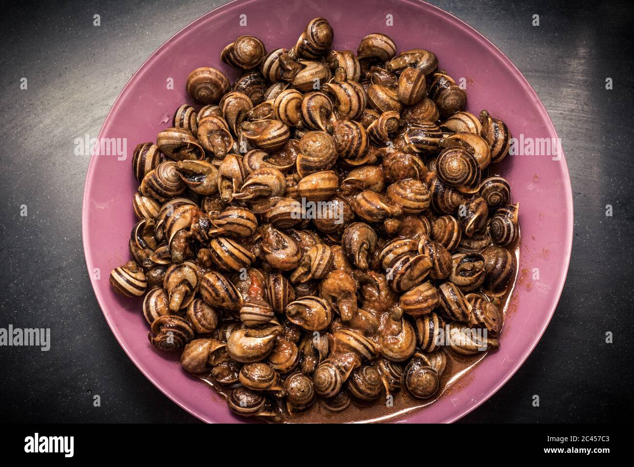 Closeup shot of a dish consisting of snails marinated with hot sauce Stock Photo
