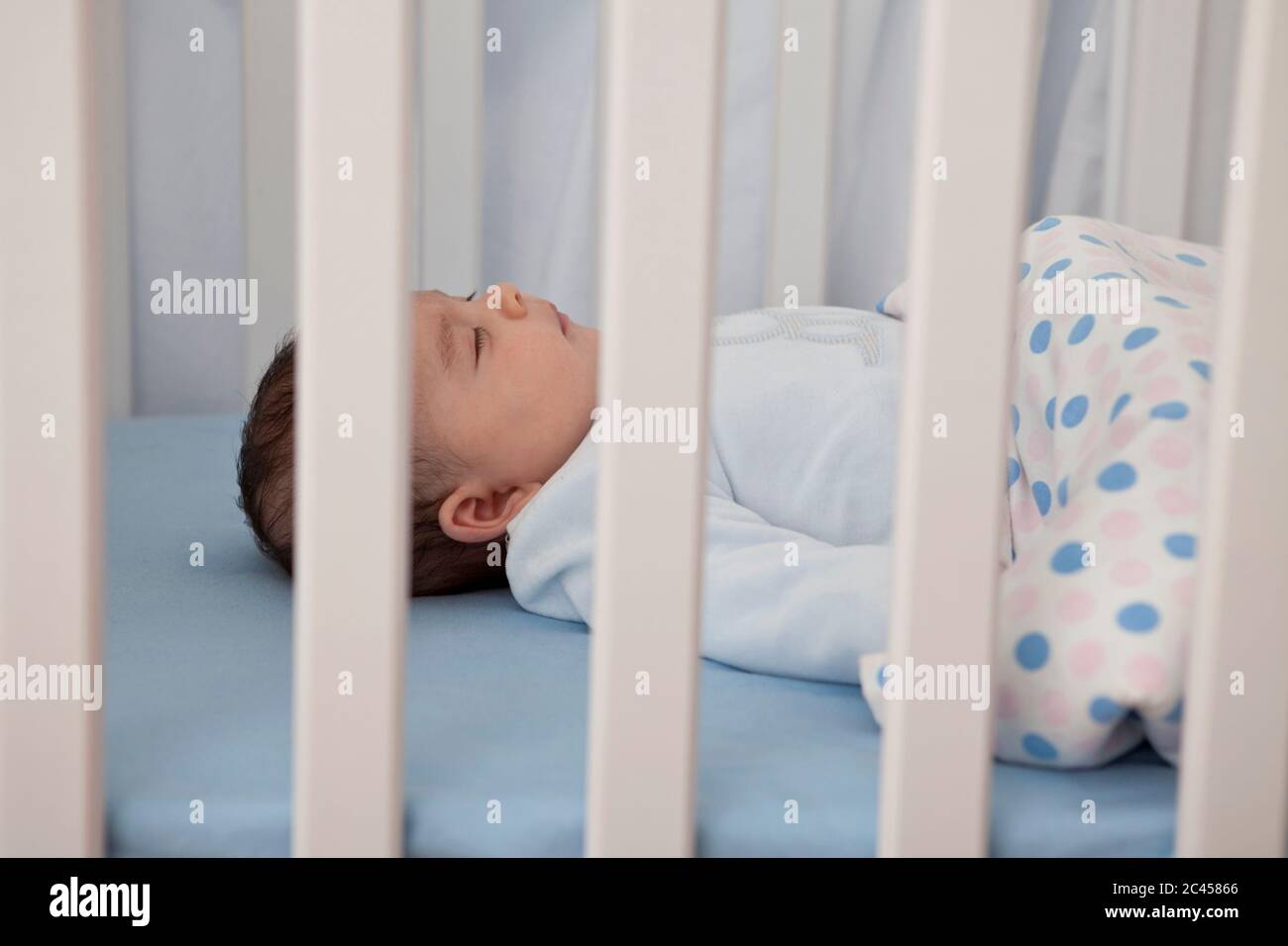 Baby sleeps in the cot Stock Photo Alamy