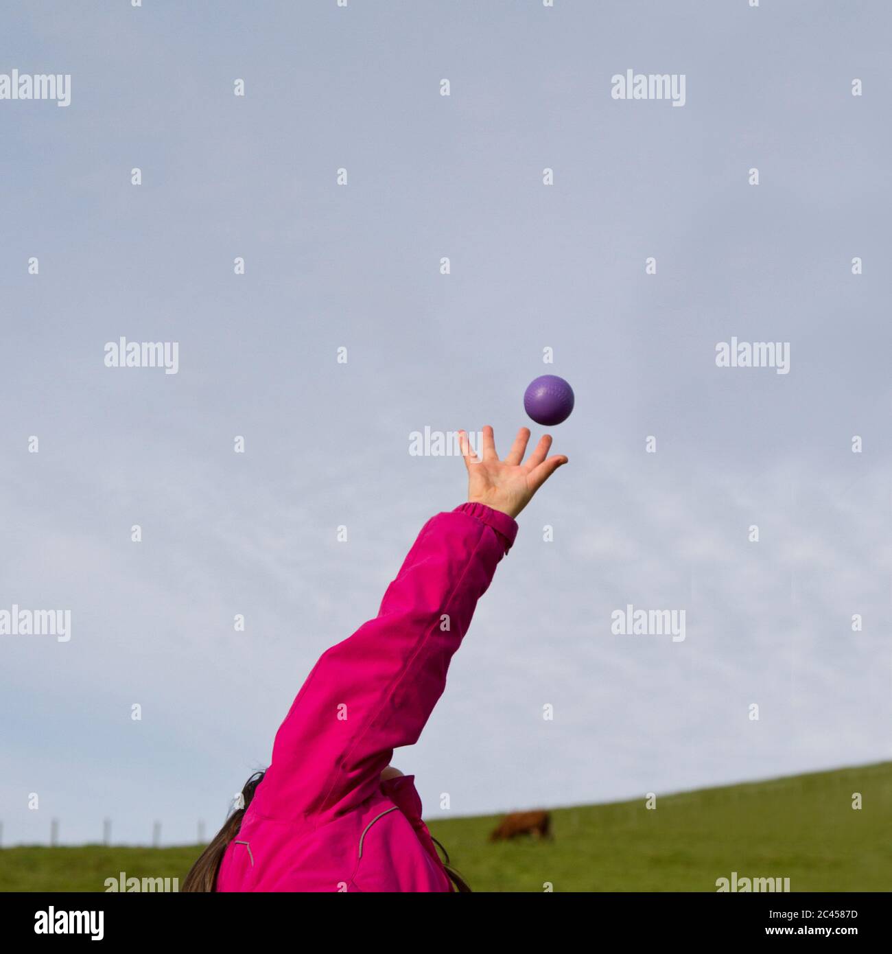 Young girl catching a ball Stock Photo