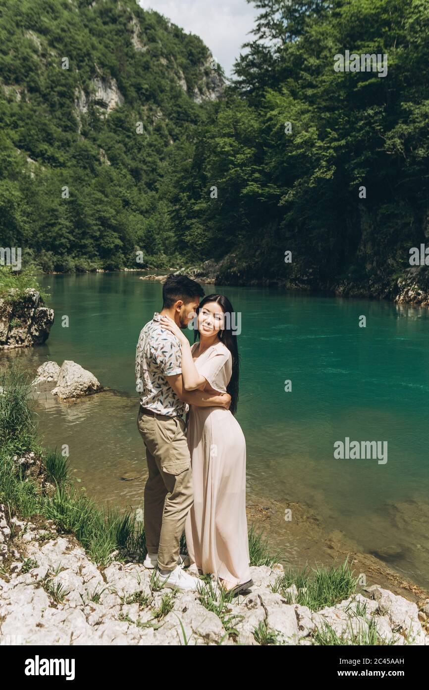 Young couple in the nature. A man hugs a woman. Stock Photo