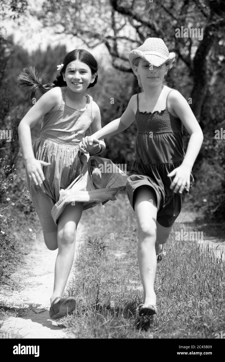 Two girls walk hand hi-res stock photography and images - Alamy