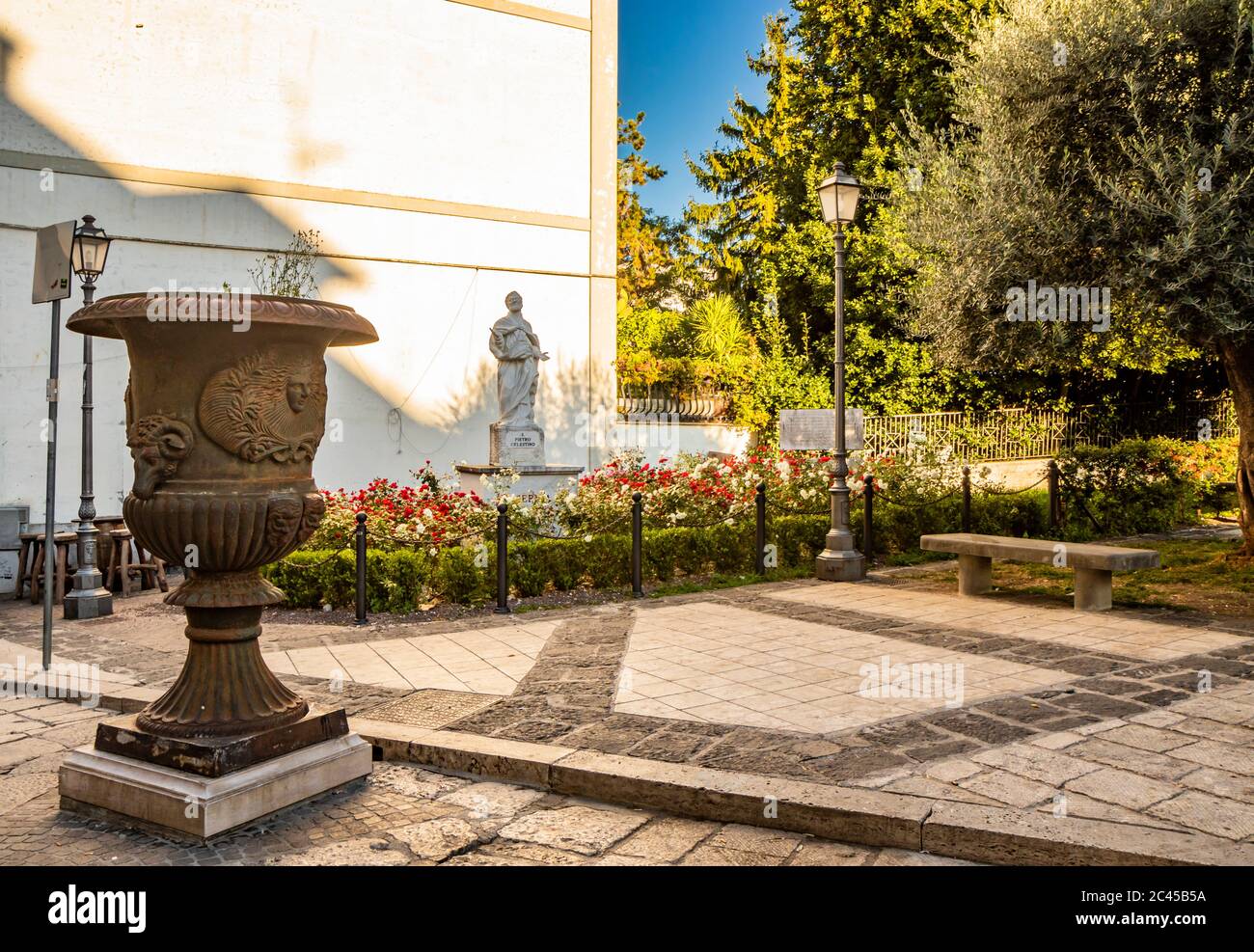 The statue of San Pietro Celestino in the garden of the homonymous square in the city of Isernia. A large bronze vase with the bas-relief of a human f Stock Photo