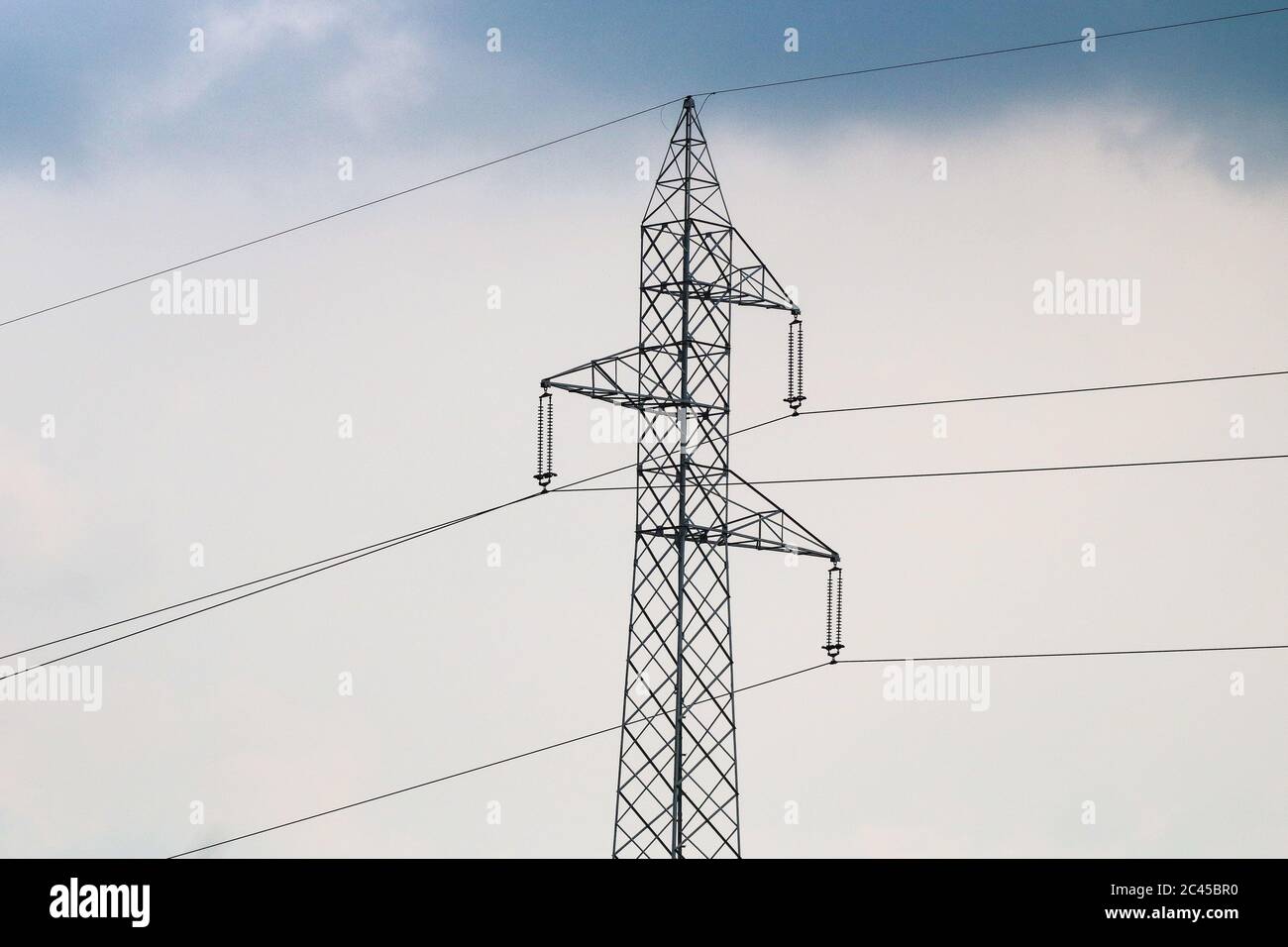 high voltage power lines and a cloudy sky Stock Photo - Alamy