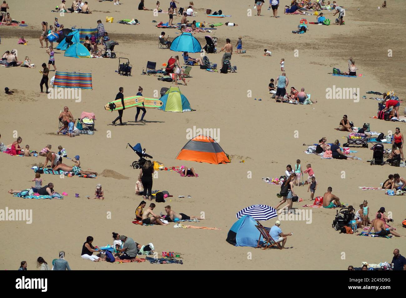 People enjoy the sunshine on Tynemouth beach as Britain is braced for a June heatwave as temperatures are set to climb into the mid-30s this week. Stock Photo
