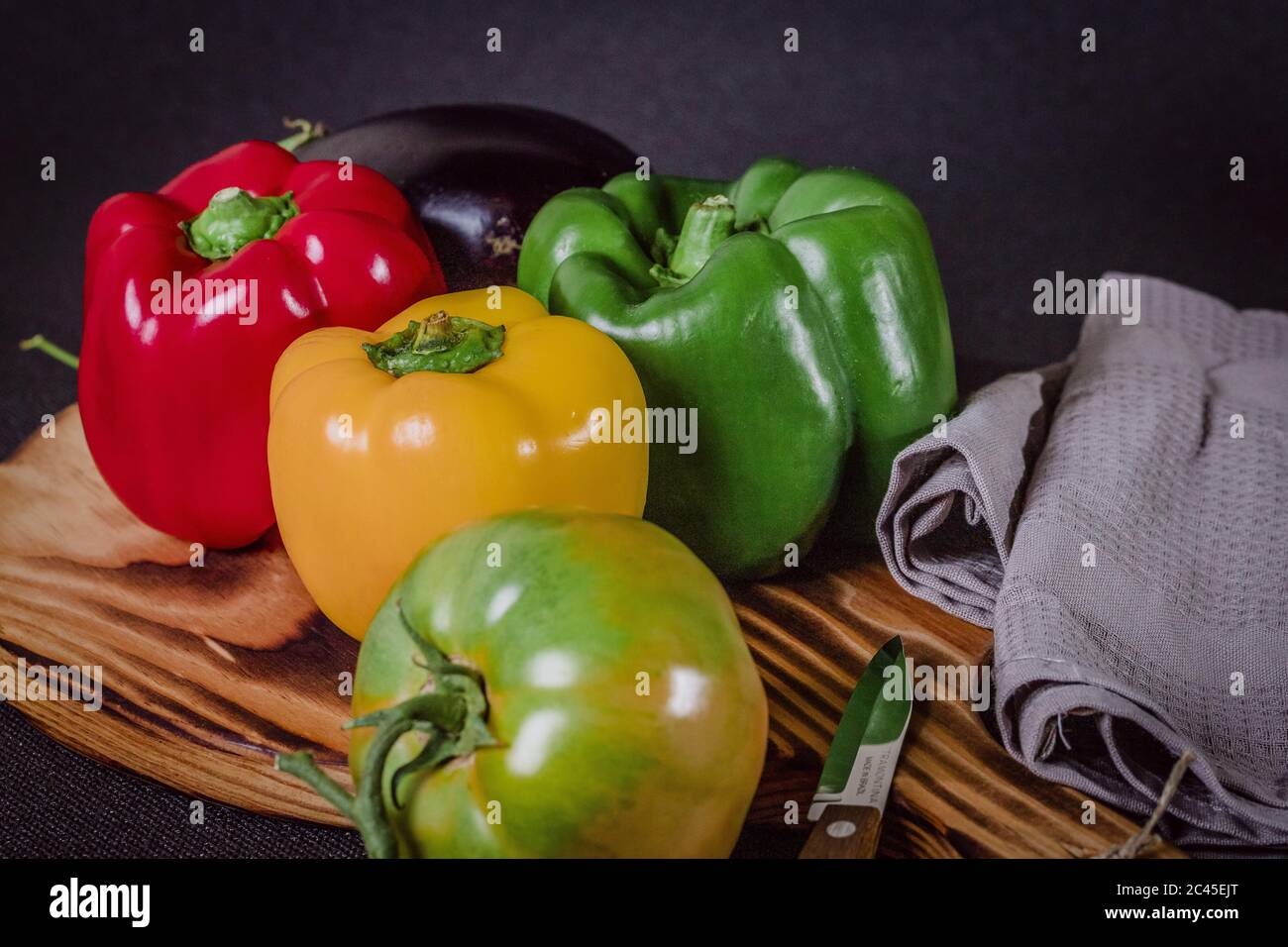 Fresh colorful peppers and eggplant on a cutting wood Stock Photo - Alamy