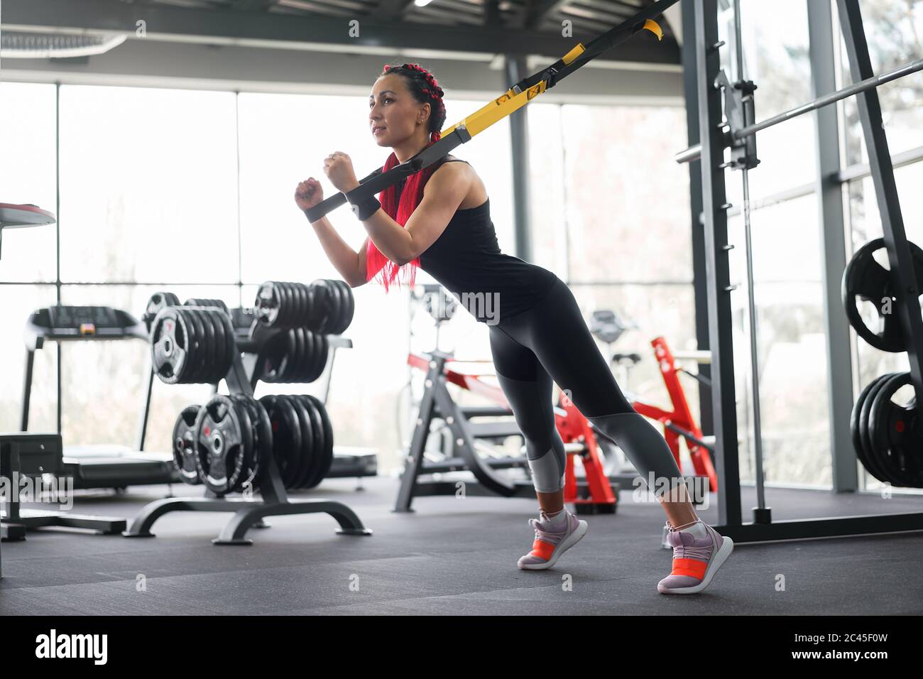 Athlete woman training exercising with suspension system indoor gym. Beautiful caucasian sportive woman do stretching strenght exercise with special strap. Middle age girl workout Stock Photo Alamy