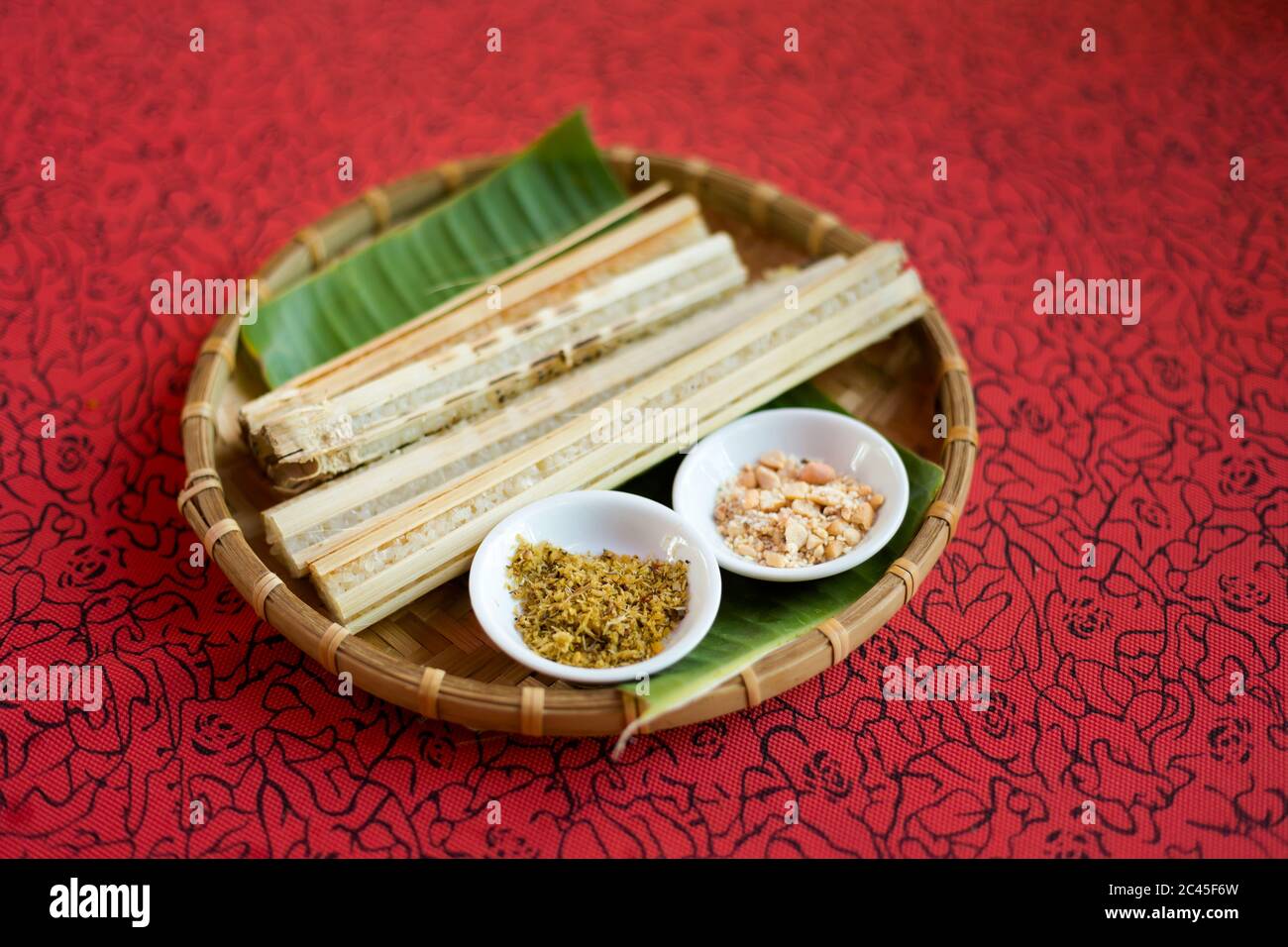 Delicious rice baked on a fire in a bamboo. Traditional vietnamese cuisine served in restaurant in Ba Ria, Vietnam. Stock Photo