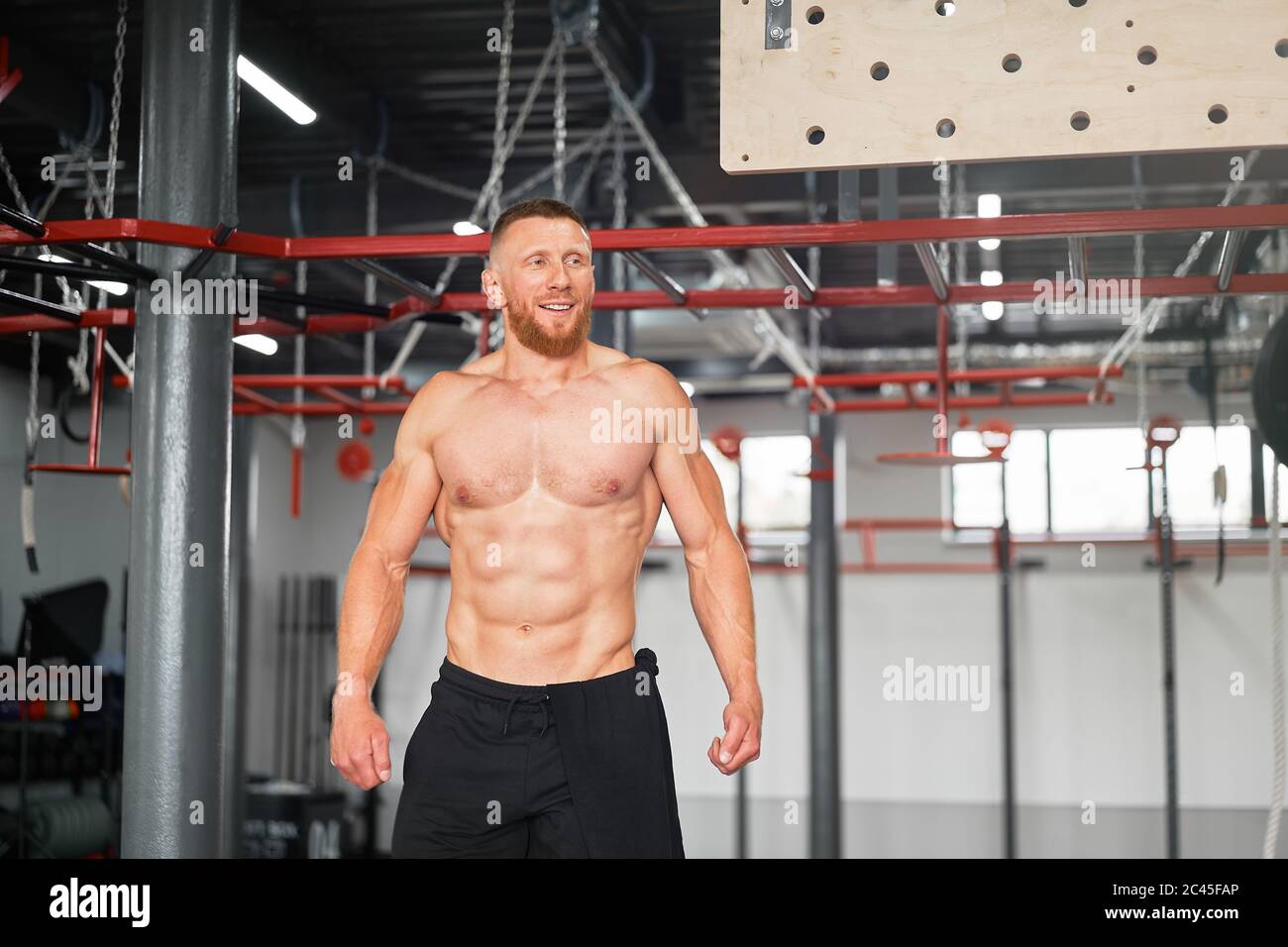 Man climbing pegboard gym athlete training arm strength stamina