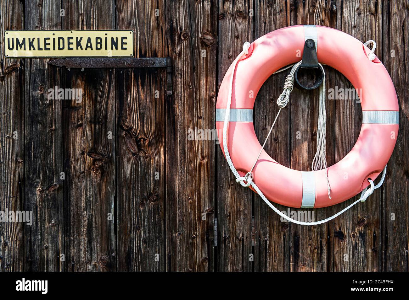 Wooden door with the locker room sign and lifebuoy Stock Photo