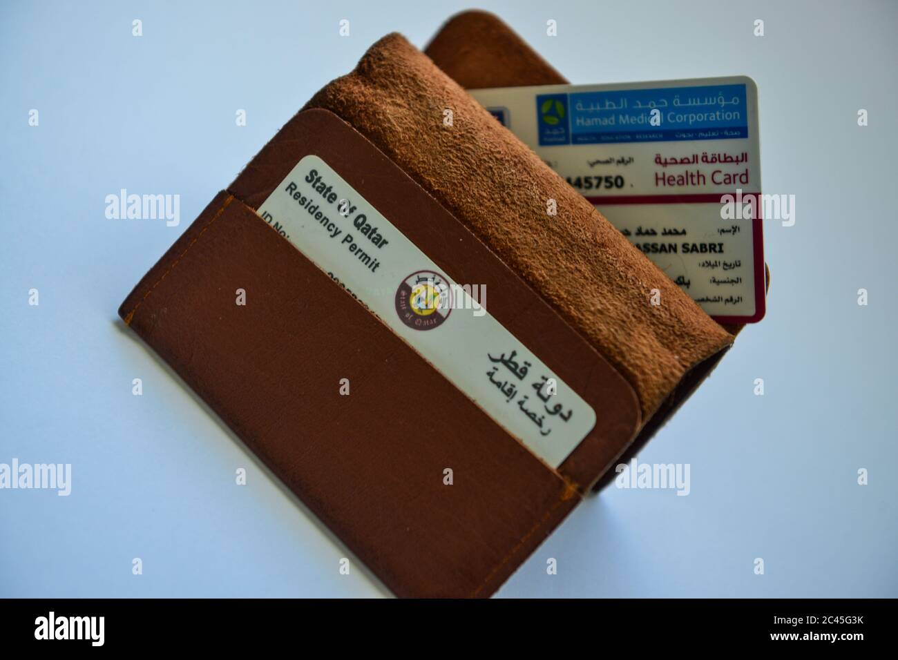 Qatar ID card & Medical Card in Brown Valet on white background Stock