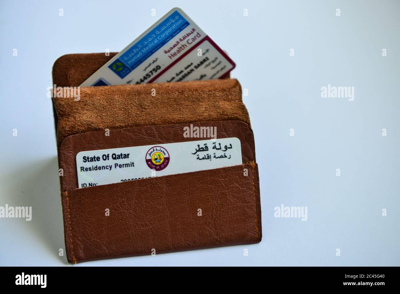 Qatar ID card & Medical Card in Brown Valet on white background Stock