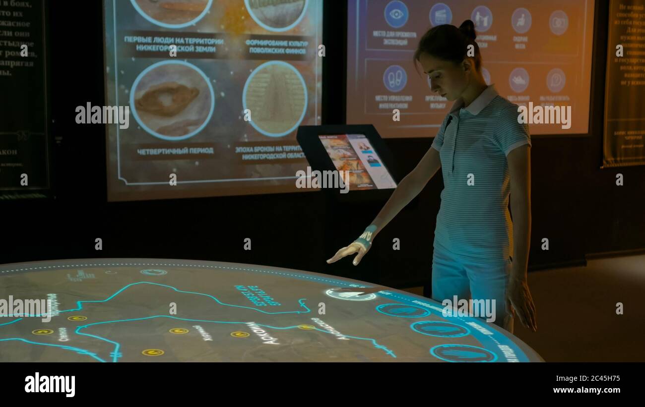 MOSCOW, RUSSIA - August 29, 2018: Modern Museum of Russia History. Woman using interactive display with no touch control technology. Education and Stock Photo