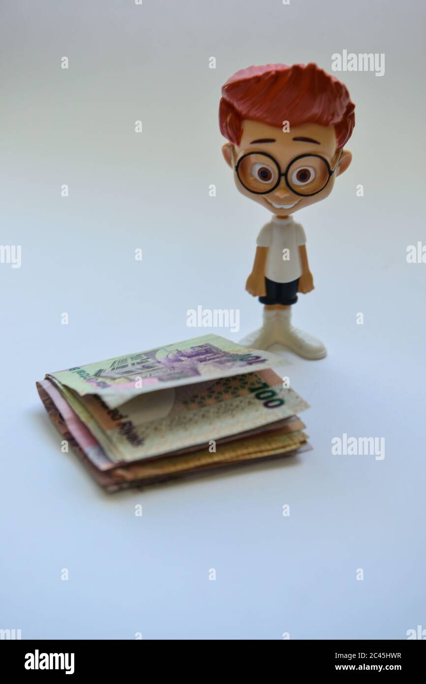 Cool boy Cartoon with Qatari currency on white background Stock Photo