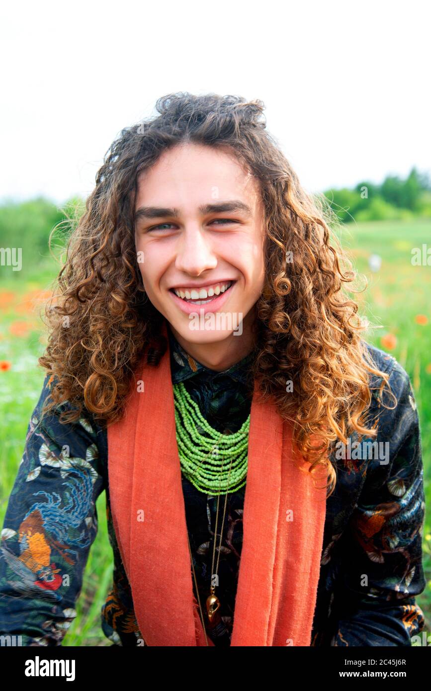 Young man with brown curly hair hi-res stock photography and images - Alamy