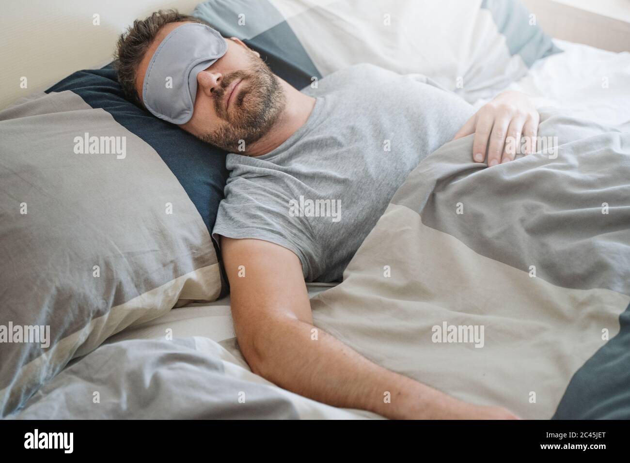 One guy sleeping and wearing an eye mask Stock Photo Alamy