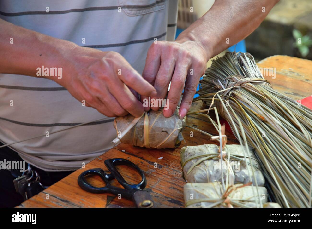 Making zongzi, a traditional Chinese rice dish which is made of ...