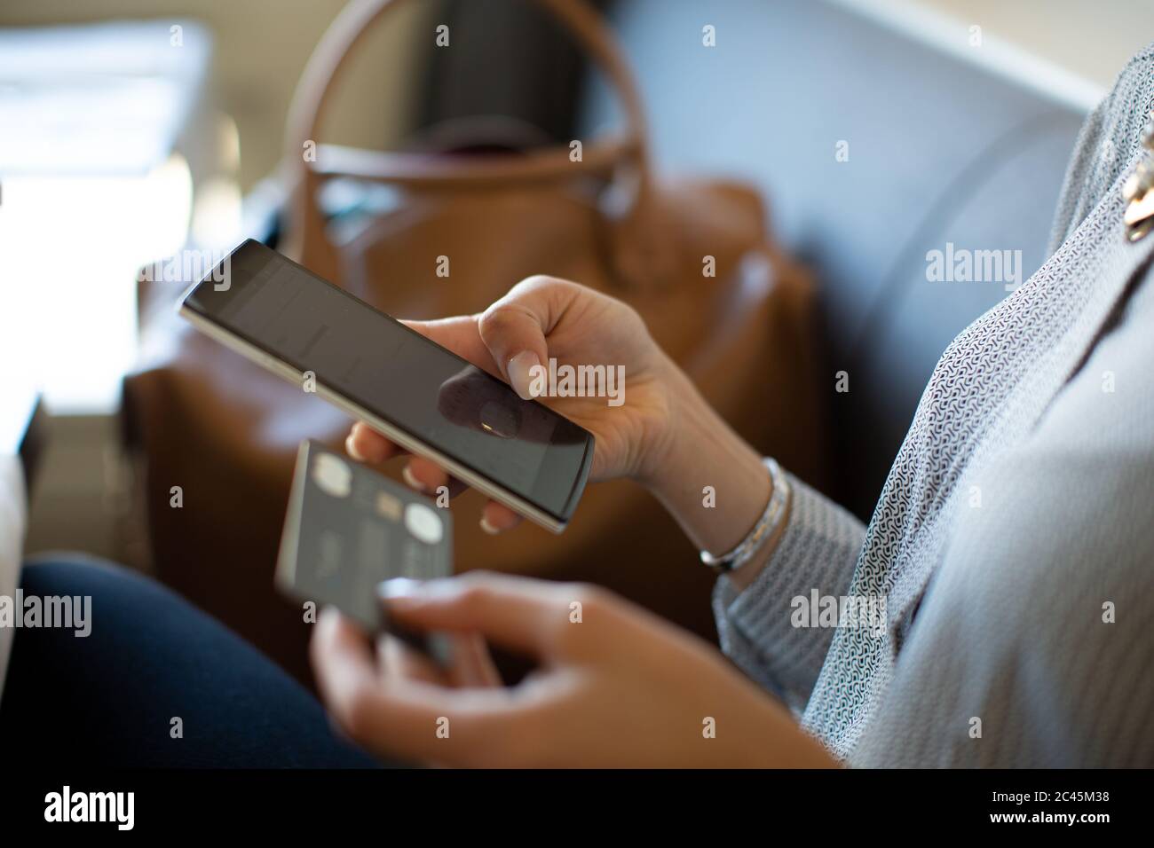 Close up of woman holding credit card and mobile phone. Stock Photo