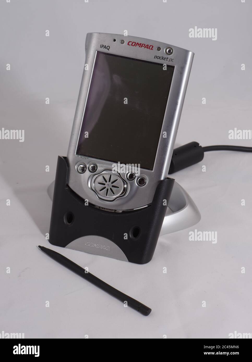 Compaq IPAQ personal digital assistant in USB cradle, an early pocket