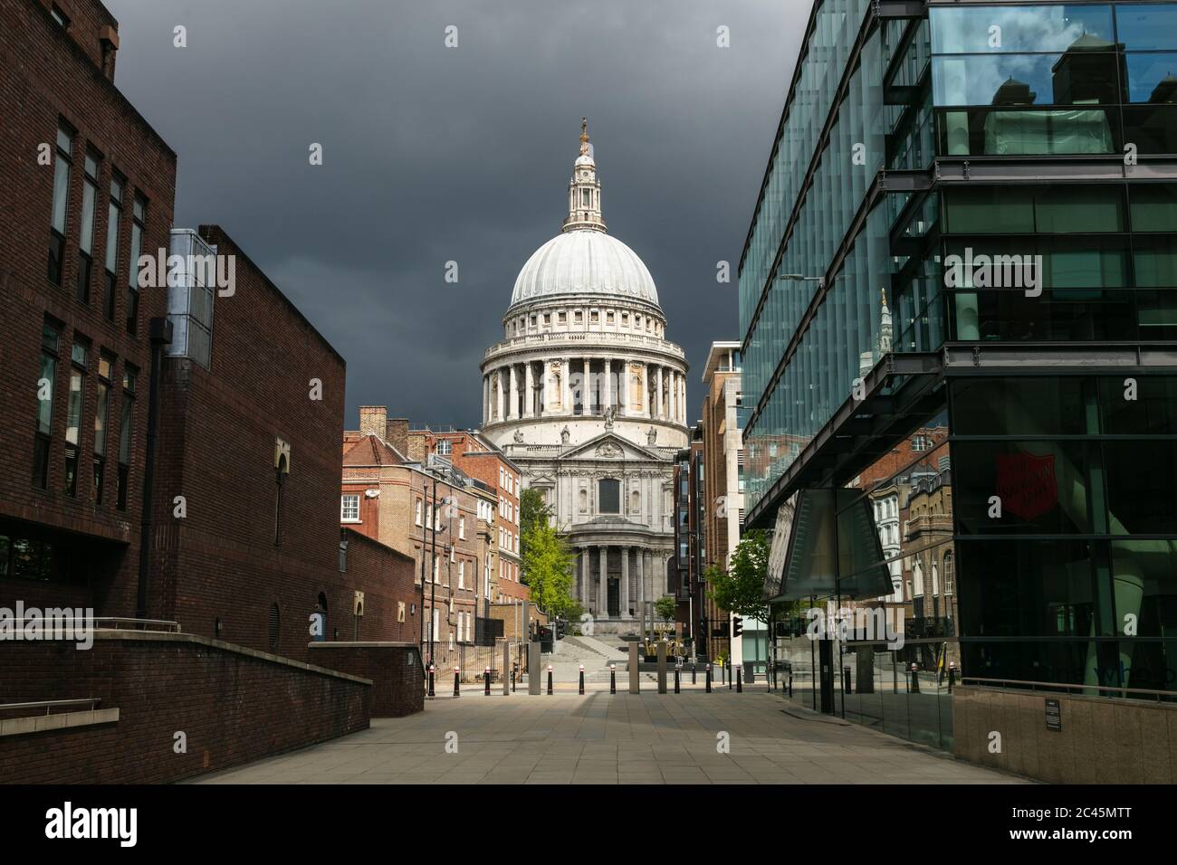 View along empty streets, Peter's Hill and St Paul's Cathedral in London under a storm sky during the Corona virus crisis. Stock Photo