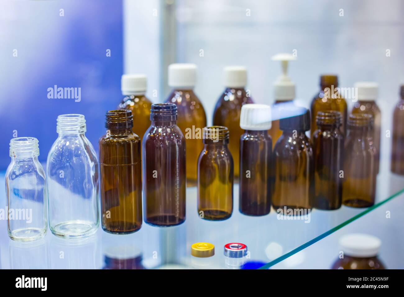 Pharma industry, science, medicine, experiment and healthcare concept. Medical empty glass bottles in showcase at pharmaceutical exhibition, pharmacy Stock Photo
