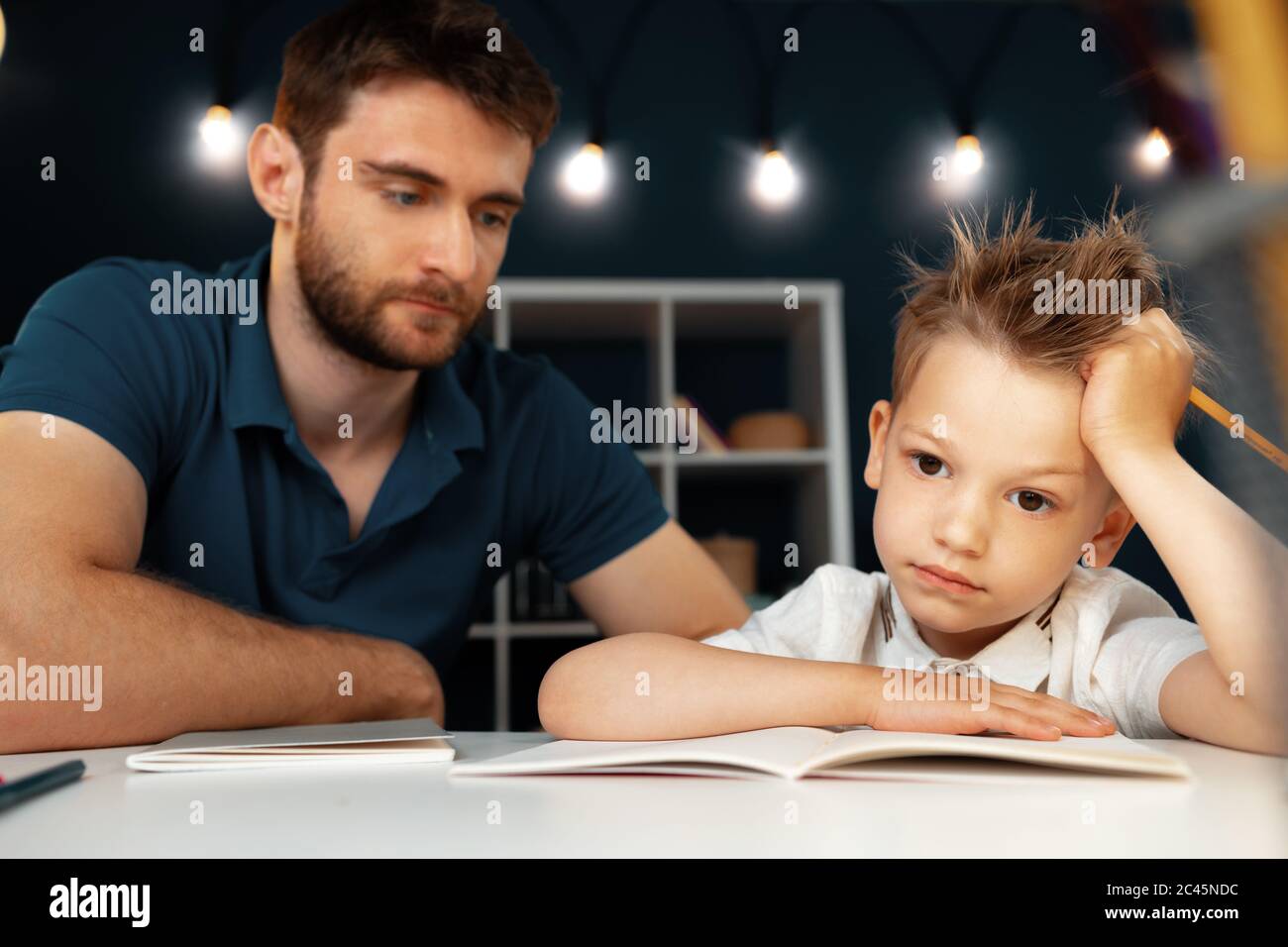 Father helping his little son with school homework Stock Photo - Alamy
