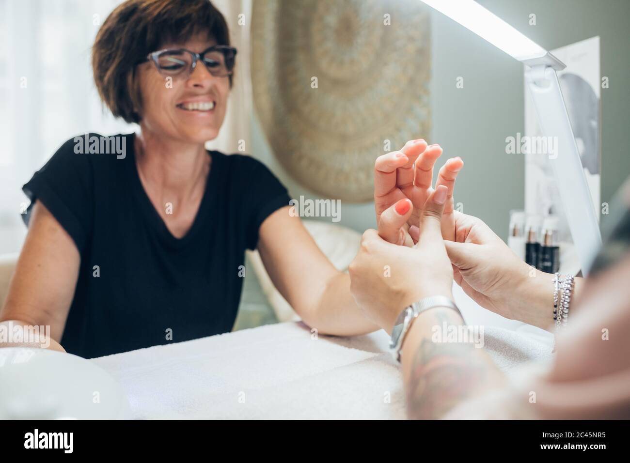 Woman getting a manicure in a beauty salon Stock Photo Alamy