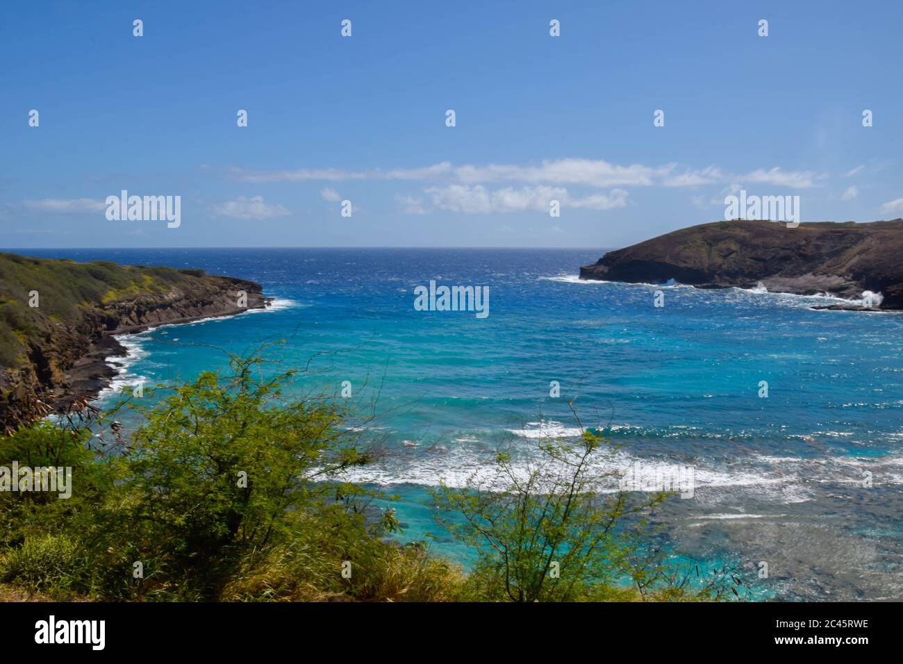 Rocky coast of the sea with clear water and blue sky Stock Photo - Alamy