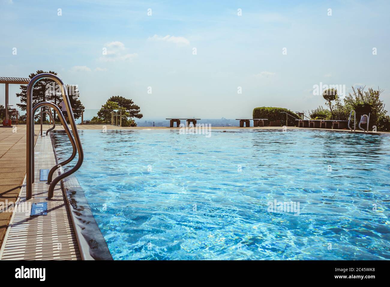 Outdoor swimming pool with beautiful view over city Stock Photo