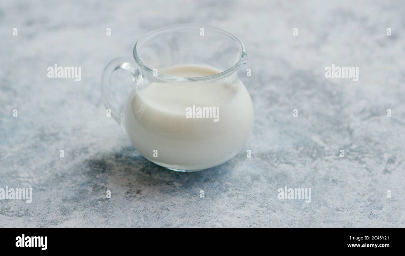 Small cream pitcher with milk Stock Photo Alamy